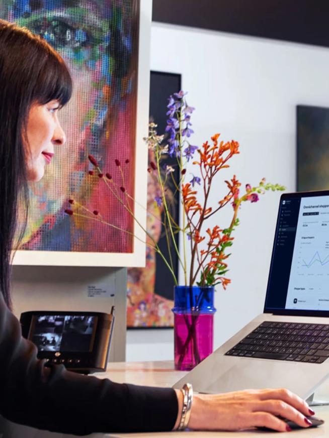 Woman on laptop in art gallery