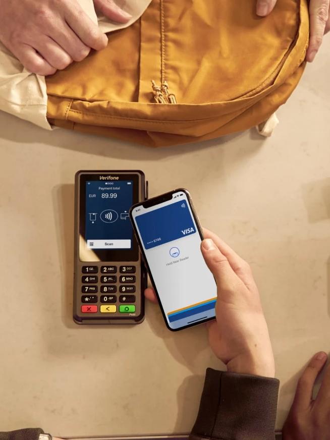 Photograph of shopper paying with mobile in store