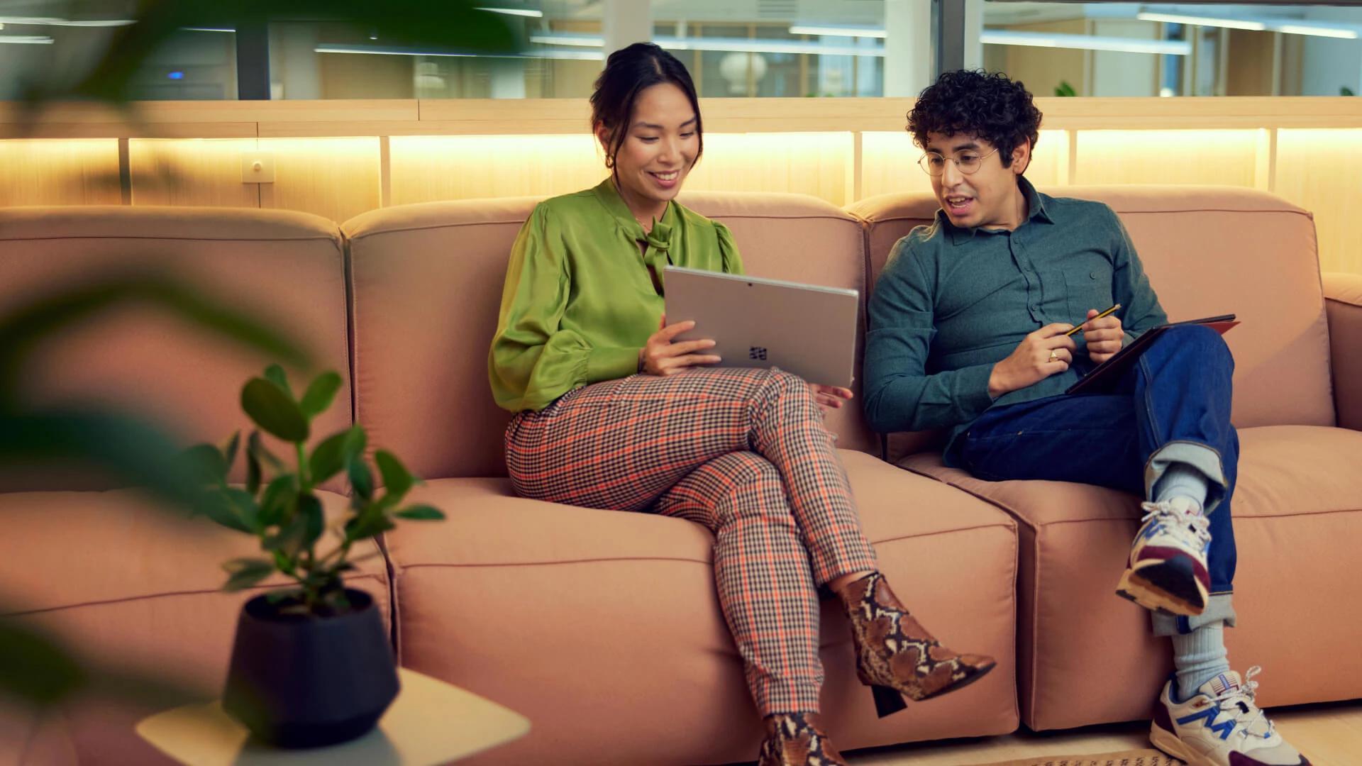 Two people discussing embedded financing on a sofa
