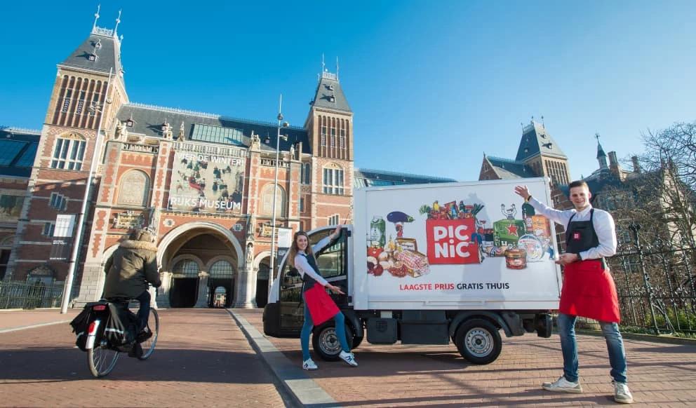 Picnic supermarket van and employees outside The Rijksmuseum, Amsterdam.