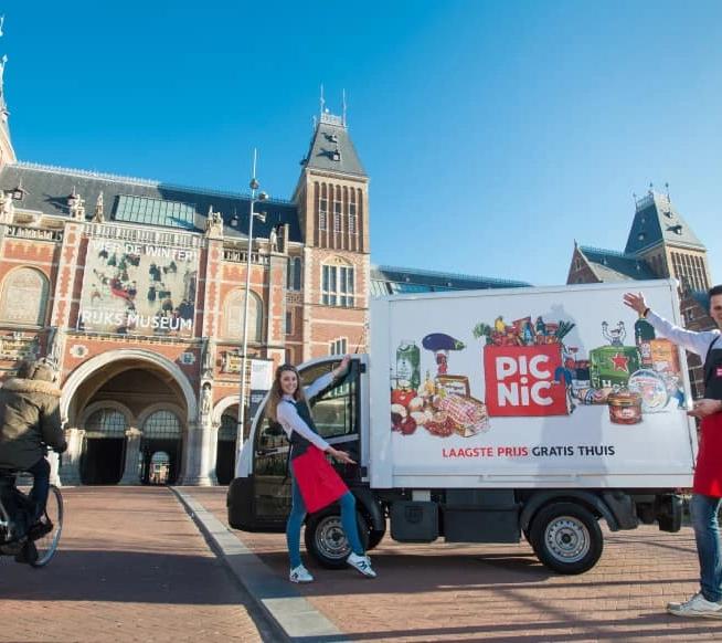 Picnic supermarket van and employees outside The Rijksmuseum, Amsterdam.