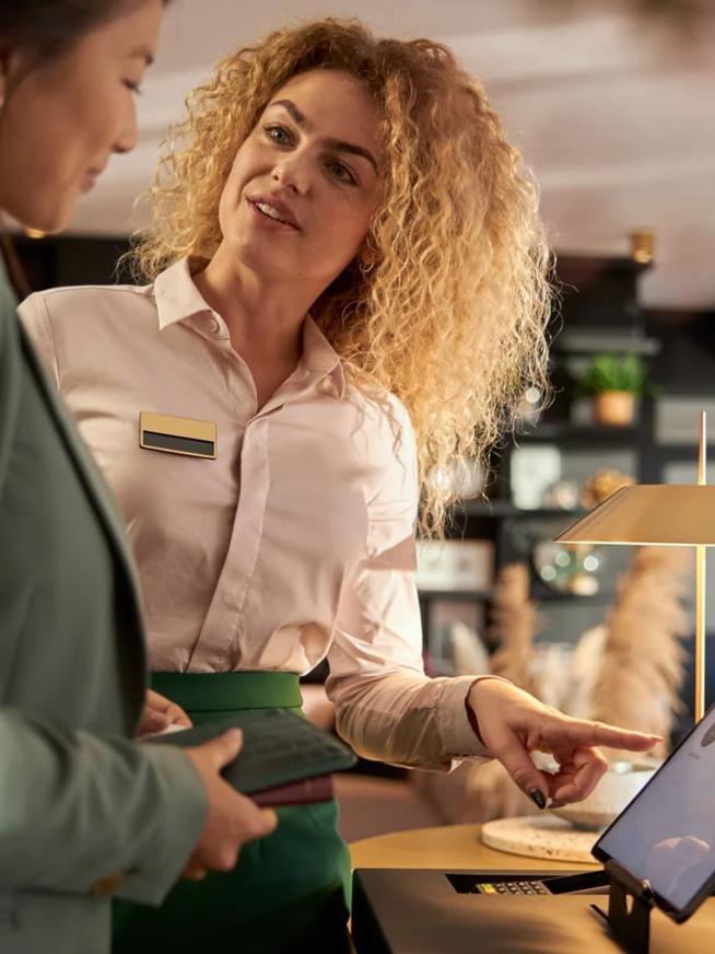 A women helping a customer check into a hotel